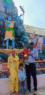 Family visiting a vibrant spiritual statue with colorful scenery.