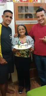 Happy family celebrating with cake at home.