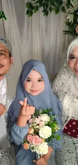 Smiling family in formal attire with floral backdrop.