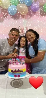 Family celebrating birthday with pastel decorations.