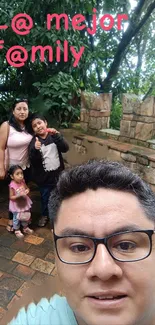 Family in nature on brick path with lush greenery.