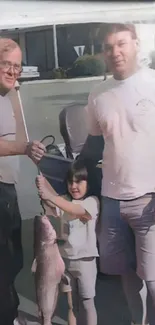 Family with a large catfish catch on a sunny day.