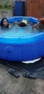 Three people enjoy a backyard inflatable pool.