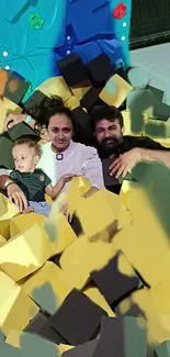 Family enjoying fun time in a colorful foam pit.