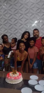 Family posing together with cake and smiles.