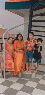 Family on rooftop with spiral stairs and colorful attire.