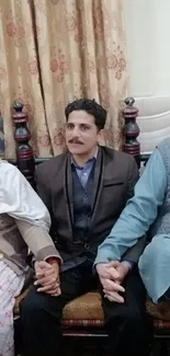 Family sitting together in warm traditional attire.