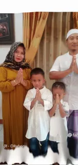 Family in traditional attire, hands joined in gesture.