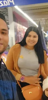 Family enjoying Halloween decor at the mall with pumpkins and festive costumes.