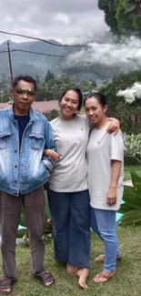 Family smiling in a lush, green mountain setting.