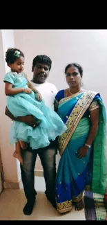 Family in blue and green traditional Indian attire.