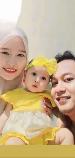 Smiling family with baby in yellow dress captures vibrant joy.