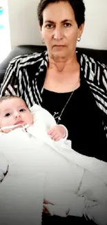 Grandmother holding infant in peaceful embrace, creating a warm family moment.