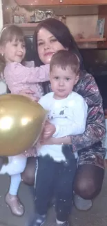 Family enjoying time together with a golden balloon indoors.