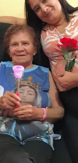 Family members sharing a special moment holding colorful roses on a couch.