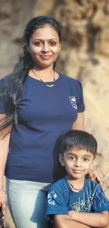 A heartwarming scene of a mother and child in a sandy outdoor setting.