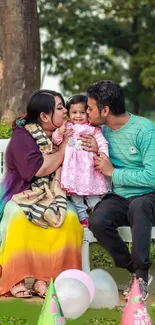 Family enjoying a park picnic on a sunny day with colorful surroundings.