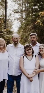 Family portrait taken in a forest setting with natural greenery.