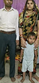 A family portrait in traditional clothing with a purple curtain backdrop.