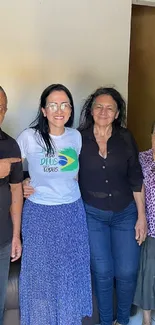 Group of four people smiling in a cozy home setting.