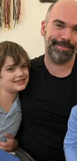 Father smiling with two young sons in a cozy family setting.