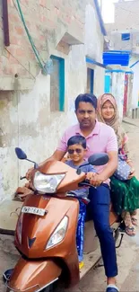 Family riding a scooter down a rustic street.