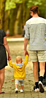 Family walking in a colorful autumn park with lush green trees.