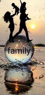 Family silhouettes in a sunset reflection on a beach with a glass sphere.