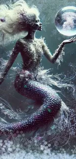 Mystical mermaid holding a glowing orb underwater.