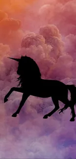 Silhouette of a unicorn against colorful clouds.