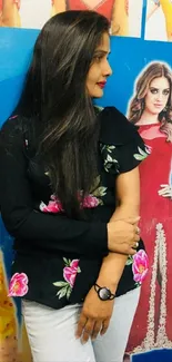 Woman in a floral top with colorful attire background.