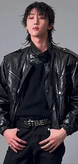 Fashionable person in black leather jacket, trendy style.