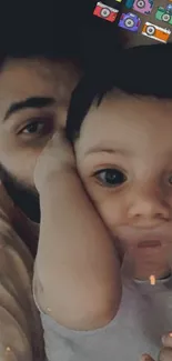 Father cuddling his baby on bed with colorful camera icons.