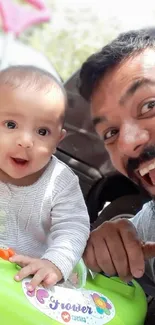 Father and baby smiling together in a bright, cheerful moment.