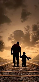 Father and child walking on railway tracks at sunset, creating a serene silhouette.