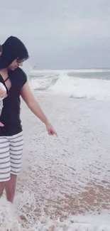 Father and child enjoying a serene moment by the ocean waves.