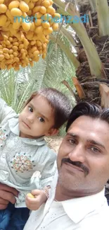 Father and child under a date palm tree in nature.