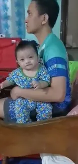 Father holding child with joy indoors.