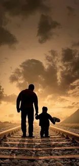 Father and child walking on railway tracks at sunset.