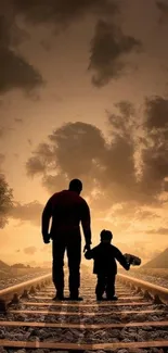 Father and child walking on railway at sunset.