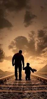 Father and child silhouette walk on railway at sunset under a golden sky.
