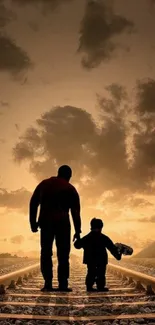 Father and child walking on railway at sunset.