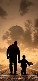 Father and child silhouetted on railroad tracks at sunset in a scenic wallpaper.