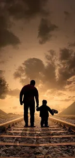 Father and child silhouette on railway at sunset, evoking tranquility.
