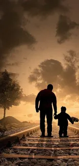 Silhouette of a father and child on railroad tracks at sunset.