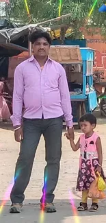 Father and daughter holding hands in a colorful street scene.