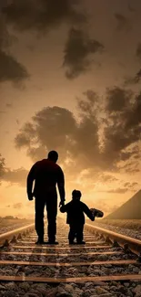 Father and child walking on railway tracks at sunset with vibrant sky.