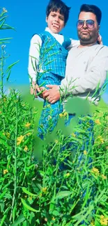 Father and son in green field with bright blue sky.