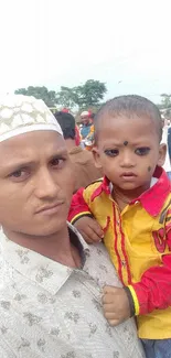 Father and young son enjoying an outdoor event.