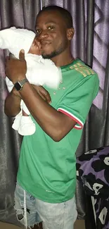 Father tenderly holding newborn baby in a serene atmosphere.